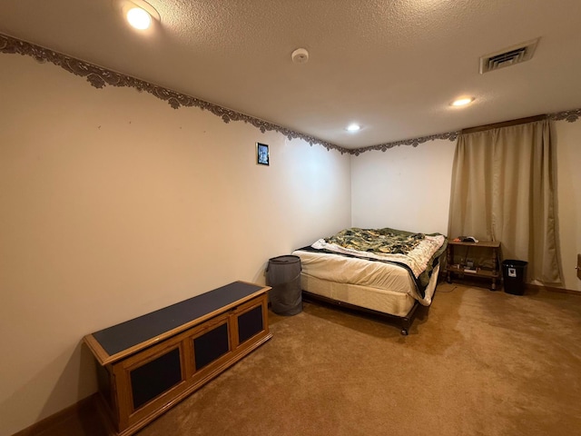 carpeted bedroom with a textured ceiling