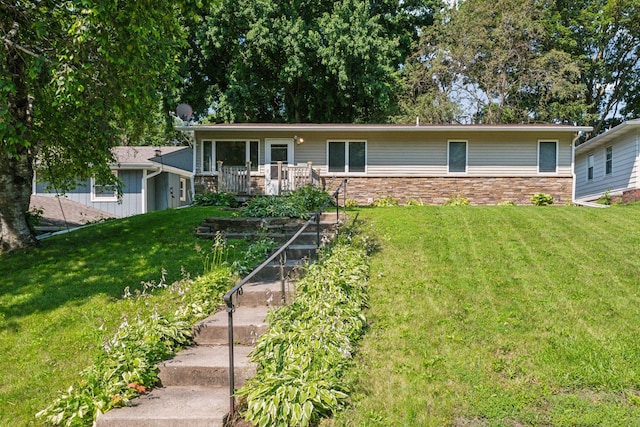 view of front facade featuring a deck and a front yard