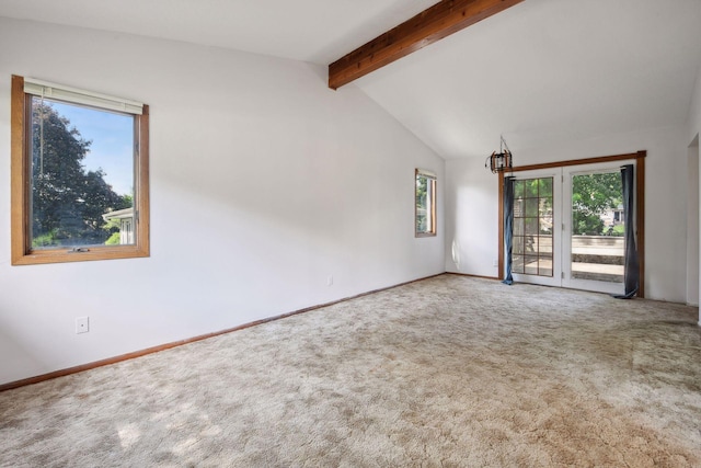 carpeted empty room featuring vaulted ceiling with beams