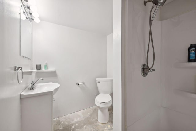 bathroom with toilet, vanity, and a shower