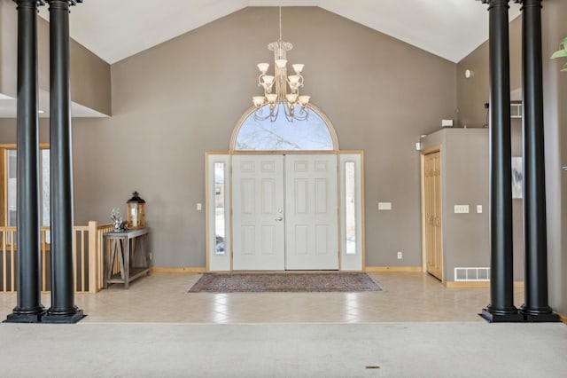 foyer featuring visible vents, a chandelier, baseboards, tile patterned flooring, and high vaulted ceiling