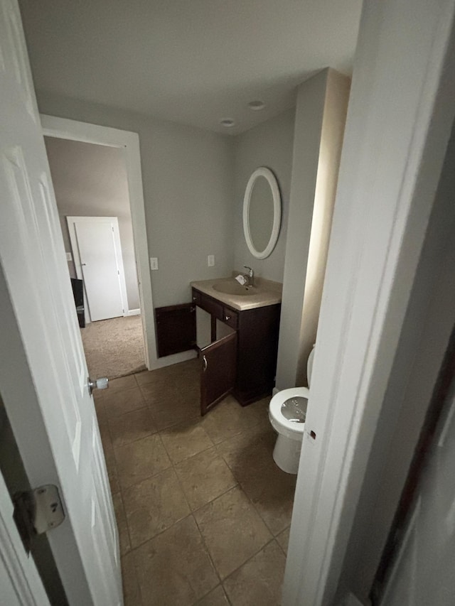 bathroom featuring toilet and vanity