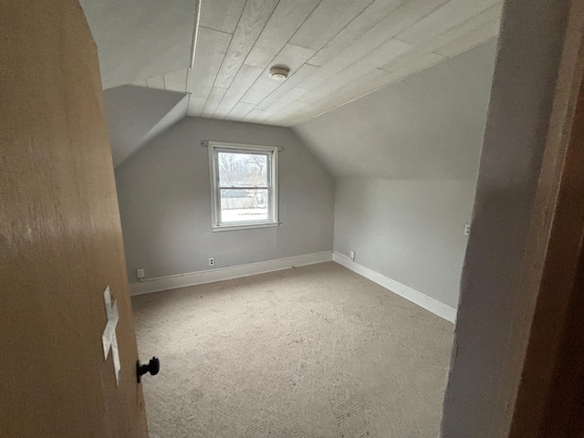 bonus room featuring vaulted ceiling and light carpet