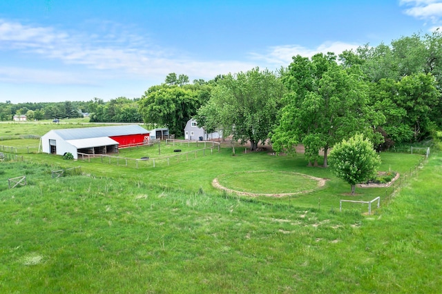 2021 Main St S, Pine City Twp, MN 55063 - view of yard featuring an outdoor structure, a view of countryside, an outbuilding, and a garage