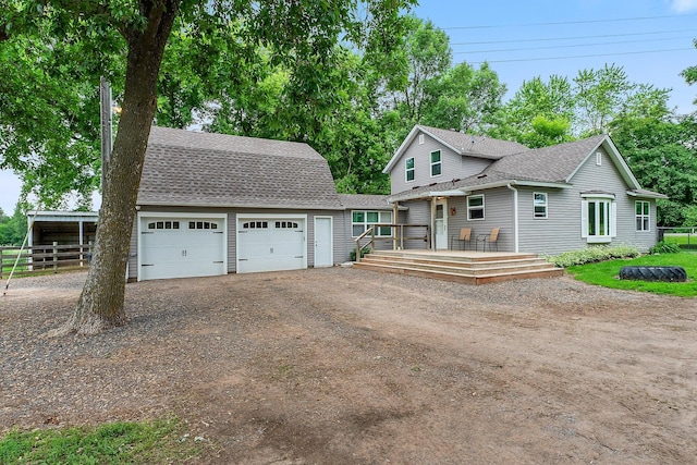 2021 Main St S, Pine City Twp, MN 55063 - view of front of property with dirt driveway, roof with shingles, a deck, an outbuilding, and a garage
