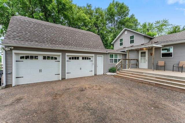 2021 Main St S, Pine City Twp, MN 55063 - view of front of property with an outdoor structure, roof with shingles, a wooden deck, and driveway