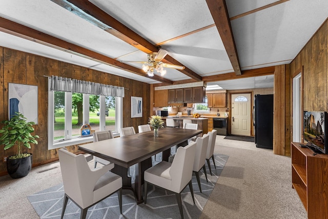 2021 Main St S, Pine City Twp, MN 55063 - dining area featuring wooden walls, beam ceiling, a ceiling fan, and light colored carpet