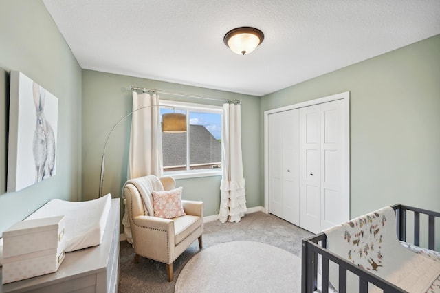 carpeted bedroom featuring a closet and a textured ceiling