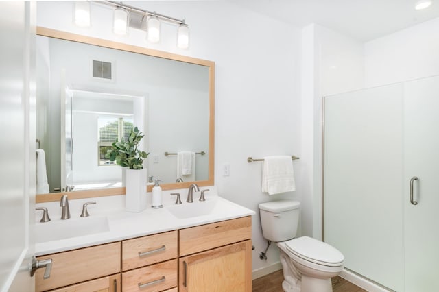 bathroom with walk in shower, vanity, toilet, and wood-type flooring