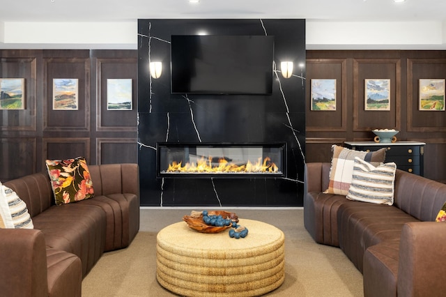 carpeted living room featuring a large fireplace