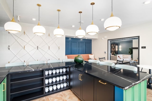 kitchen with pendant lighting and light parquet flooring