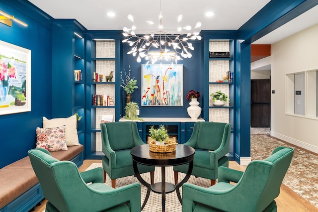 living area with a notable chandelier and light wood-type flooring