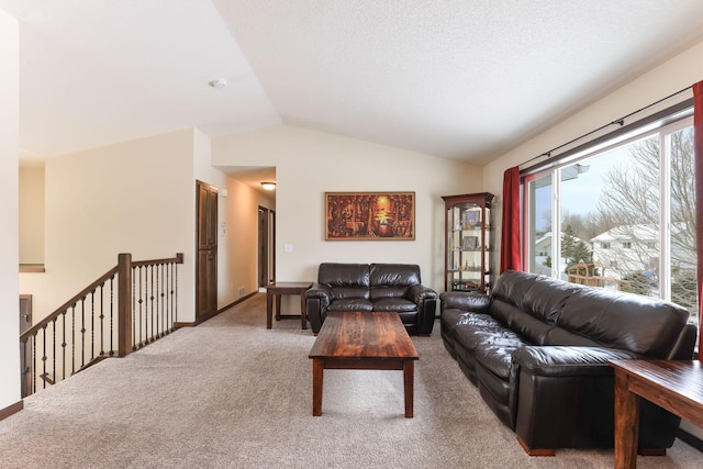 carpeted living room with lofted ceiling