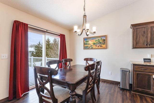 dining area with a chandelier and dark hardwood / wood-style floors