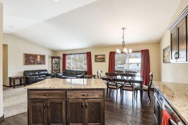 kitchen featuring decorative light fixtures, vaulted ceiling, an inviting chandelier, dark brown cabinetry, and dark wood-type flooring