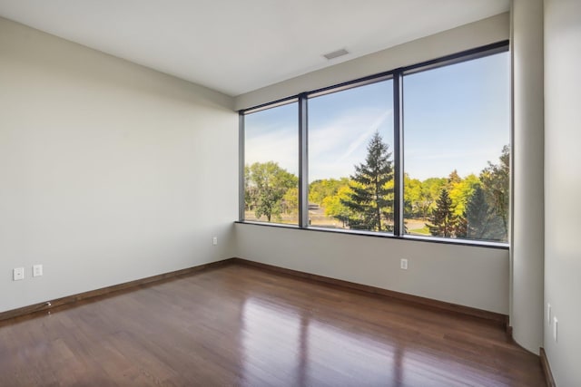 unfurnished room with hardwood / wood-style floors