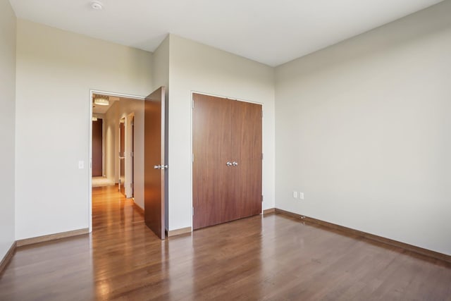 unfurnished bedroom featuring a closet and wood-type flooring