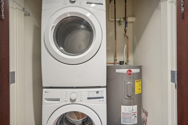 laundry area featuring electric water heater and stacked washer / drying machine