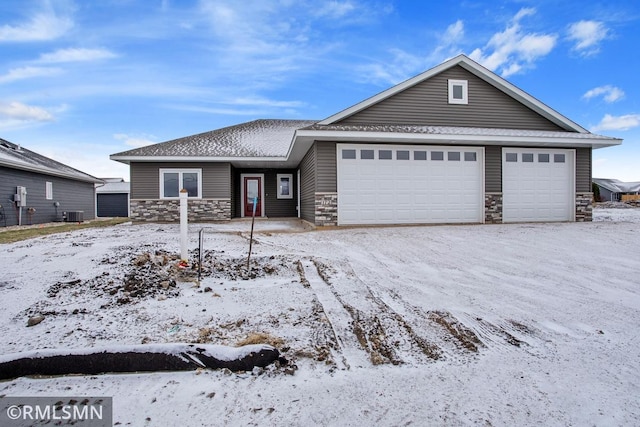 view of front of home featuring central AC unit and a garage