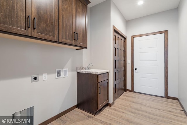 laundry room featuring hookup for an electric dryer, light wood-type flooring, washer hookup, cabinets, and sink