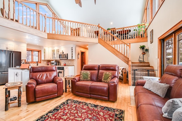 living room featuring a high ceiling and light hardwood / wood-style floors