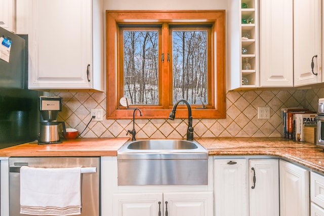 kitchen featuring white cabinetry, sink, and backsplash