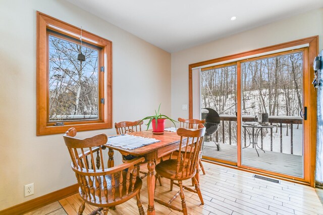 dining space with light hardwood / wood-style flooring