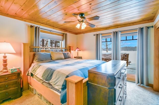 carpeted bedroom with multiple windows, wood ceiling, and ceiling fan