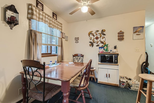 dining area with carpet floors and a ceiling fan