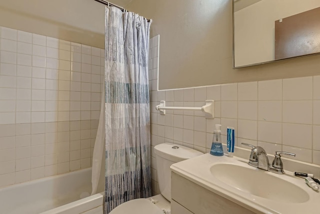 bathroom featuring toilet, shower / bathtub combination with curtain, tile walls, and a sink