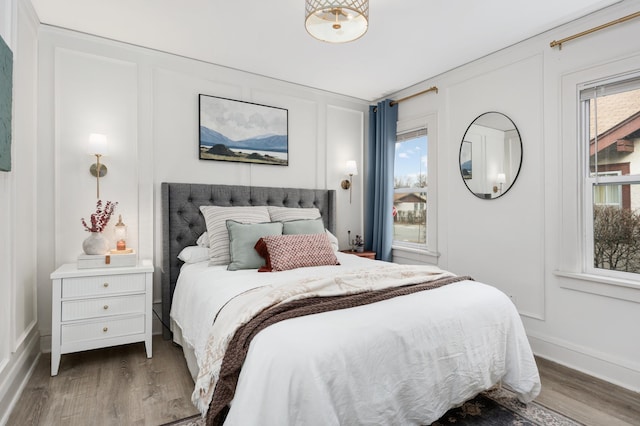 bedroom with dark hardwood / wood-style floors