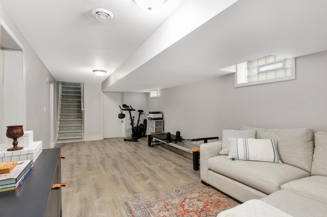 workout area with light hardwood / wood-style flooring