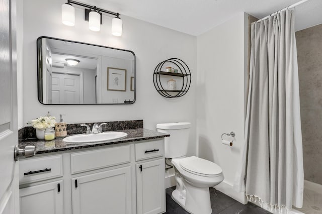 bathroom featuring toilet, vanity, a shower with curtain, and tile patterned flooring