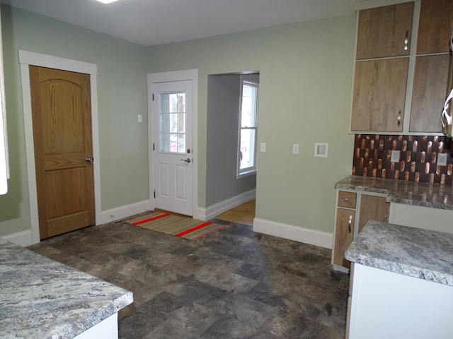 kitchen with light countertops and baseboards