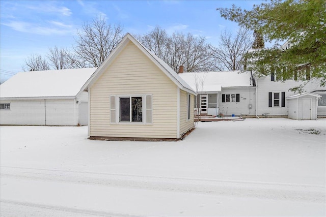 view of front of property with a storage shed