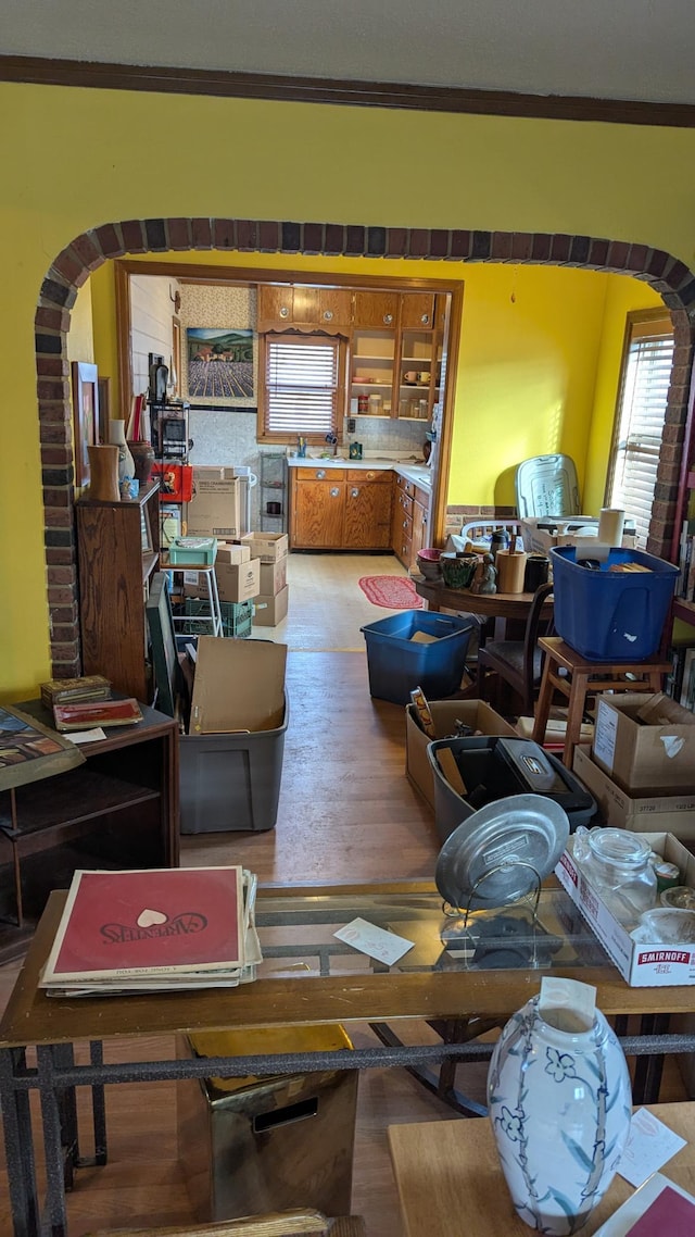 living room with wood-type flooring and crown molding