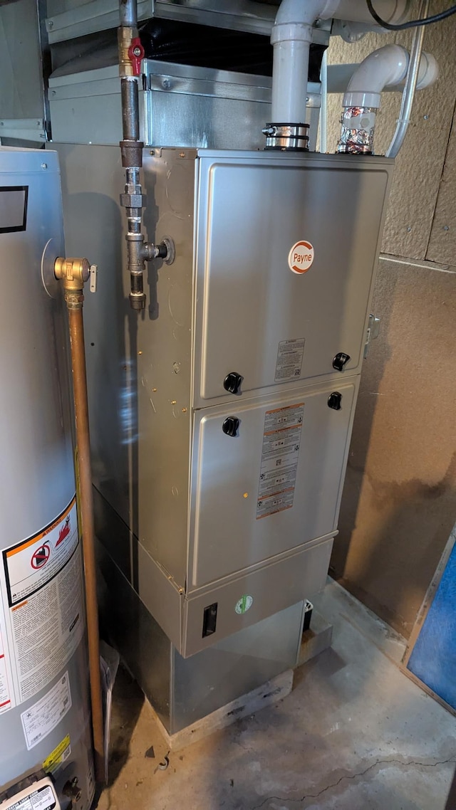 utility room with water heater and heating unit