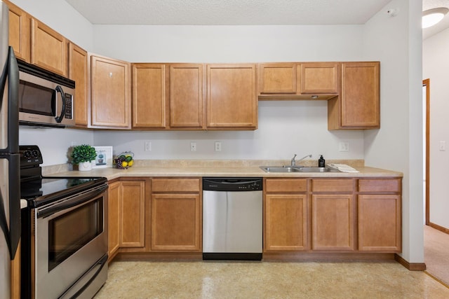 kitchen with a sink, light countertops, and stainless steel appliances