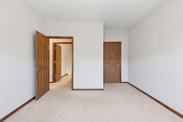 unfurnished bedroom with baseboards and light carpet