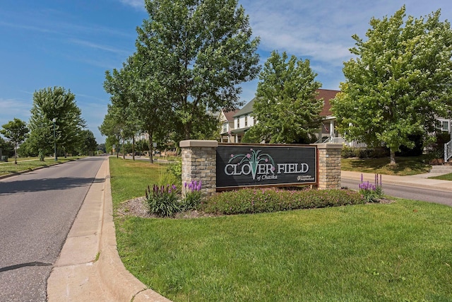 community / neighborhood sign with a lawn
