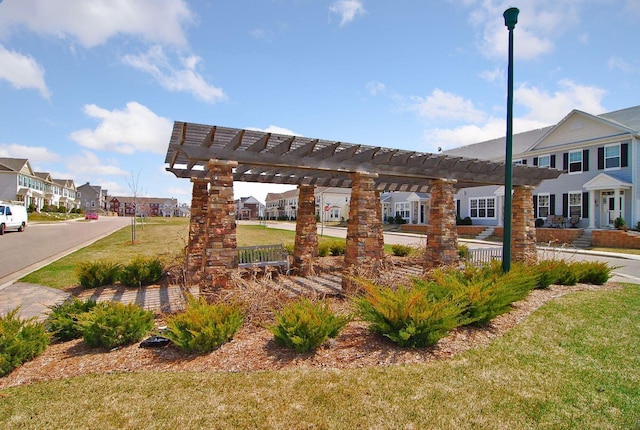 view of property's community featuring a yard, a pergola, and a residential view