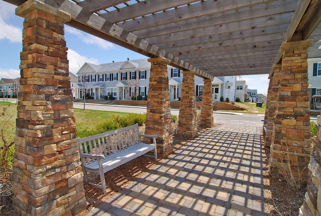 view of patio / terrace featuring a residential view, a pergola, and covered porch