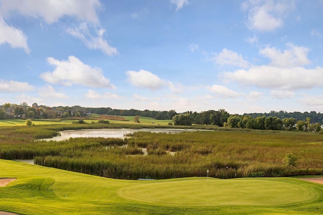 view of property's community with view of golf course and a water view