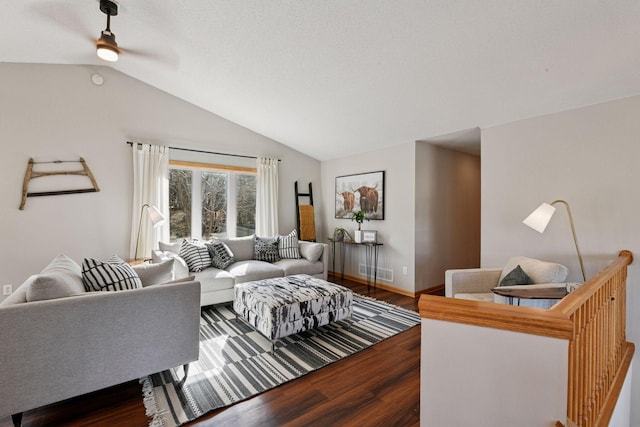 living room with visible vents, a ceiling fan, wood finished floors, baseboards, and vaulted ceiling