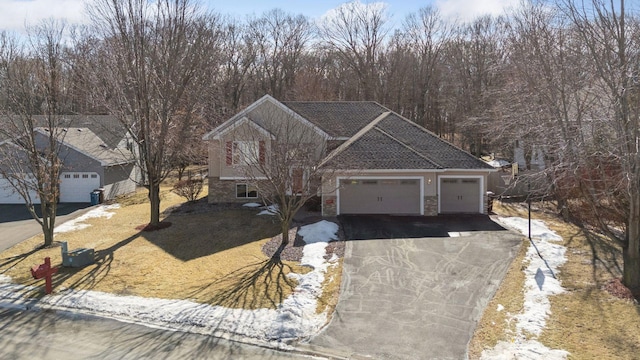 view of front of home with driveway, brick siding, and an attached garage