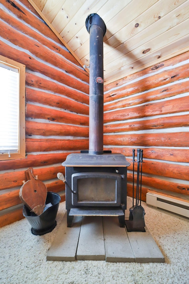 interior details featuring baseboard heating, wooden ceiling, rustic walls, and a wood stove