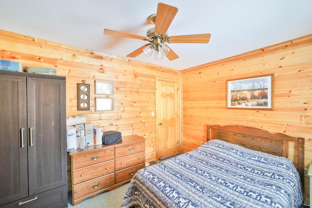 carpeted bedroom with wooden walls and ceiling fan