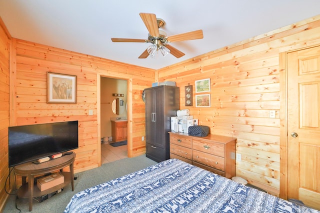 bedroom featuring light carpet, ceiling fan, and ensuite bathroom