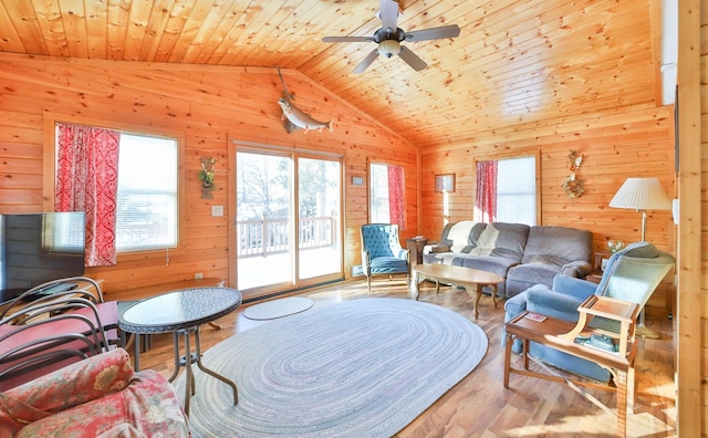 living room featuring vaulted ceiling, wood walls, wood ceiling, and light hardwood / wood-style flooring