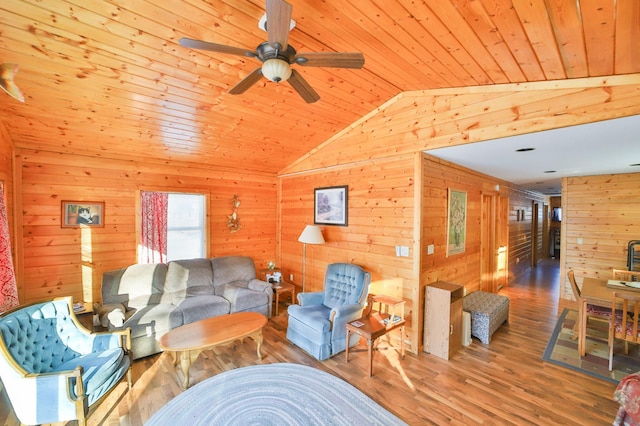 living room featuring lofted ceiling, hardwood / wood-style flooring, wooden ceiling, and wood walls